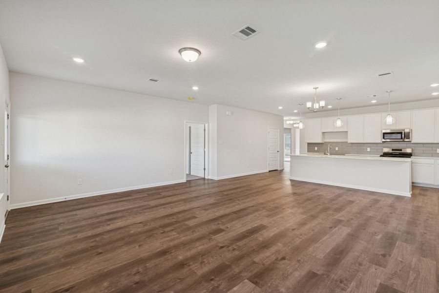 The Crawford- Family Room into Dining and Kitchen. Sample image for illustration; upgrades, options, and colors may vary. The Crawford- Family Room into Dining and Kitchen. Sample image for illustration; upgrades, options, and colors may vary.