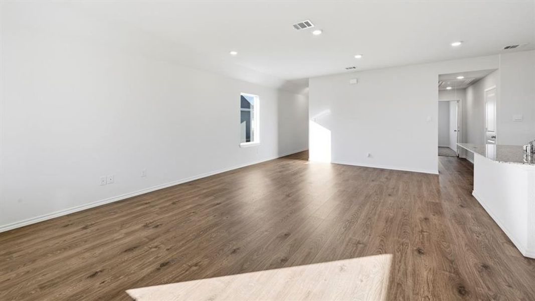 Spare room featuring dark wood-style flooring and recessed lighting Spare room featuring dark wood-style flooring and recessed lighting