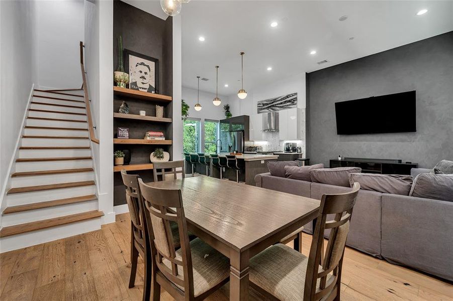 Dining room featuring light wood finished floors, recessed lighting, and stairs Dining room featuring light wood finished floors, recessed lighting, and stairs