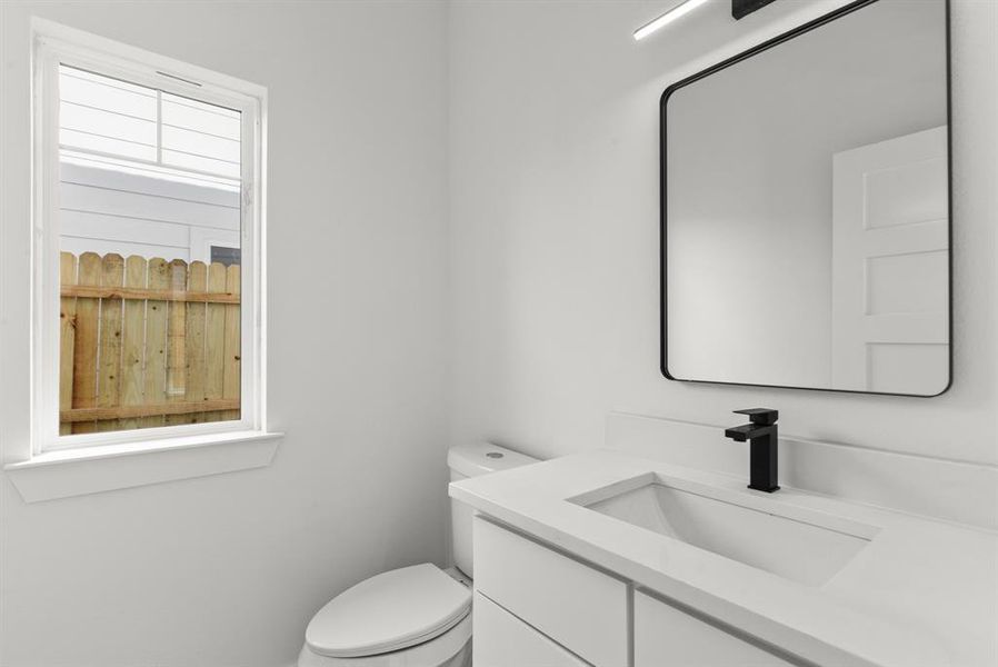 Half bath with vanity and toilet