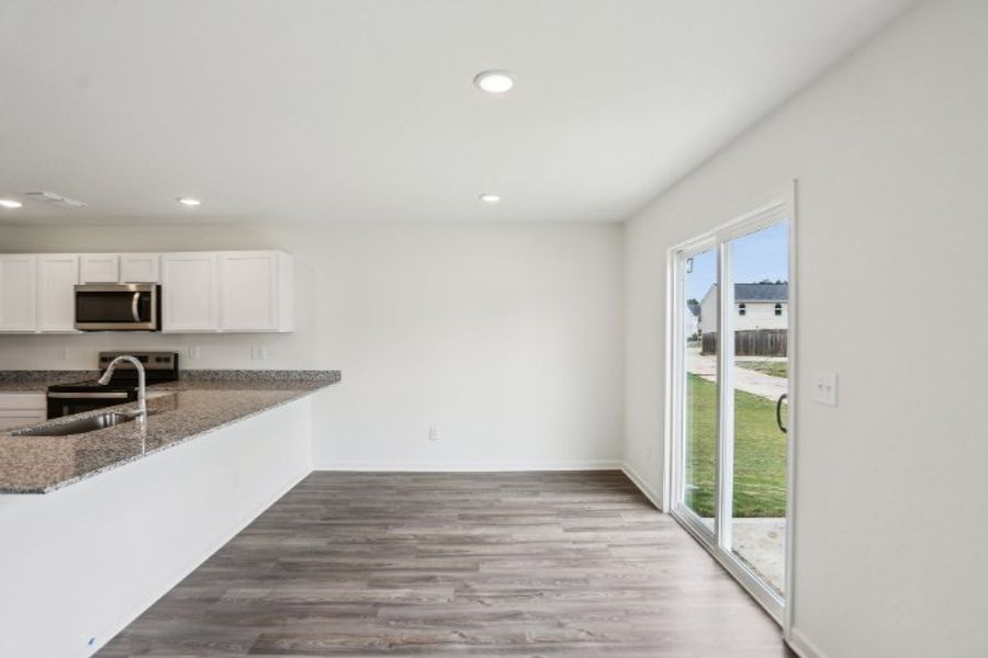A kitchen with a large glass door.