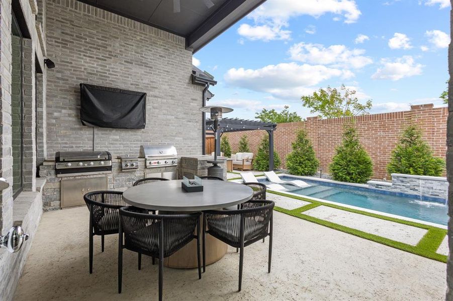 Covered patio area with outdoor kitchen and BBQ