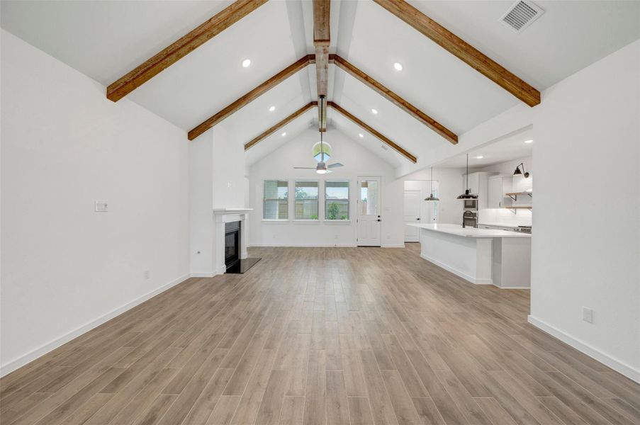 Impressive living area with high ceilings and stained beams