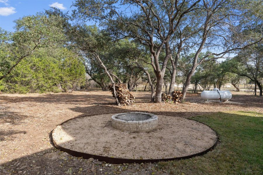 View of yard with an outdoor fire pit View of yard with an outdoor fire pit