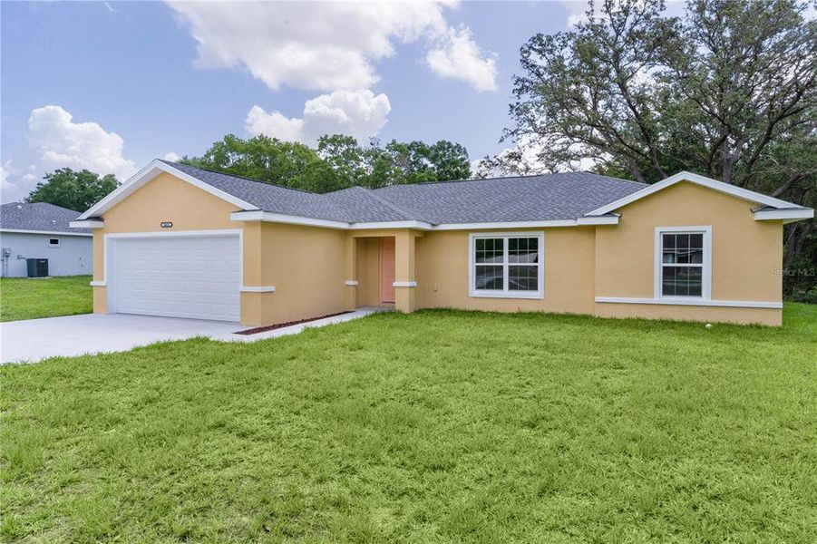 Front exterior of a new home in , Summerfield, FL, highlighting curb appeal (Image 16).
