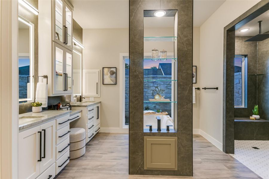 Full bathroom featuring a walk-in shower and two vanities Full bathroom featuring a walk-in shower and two vanities