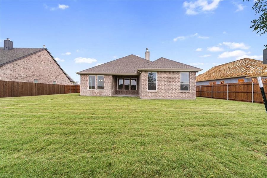 Back of property featuring roof with shingles, a patio area, a chimney, a fenced backyard, and brick siding Back of property featuring roof with shingles, a patio area, a chimney, a fenced backyard, and brick siding