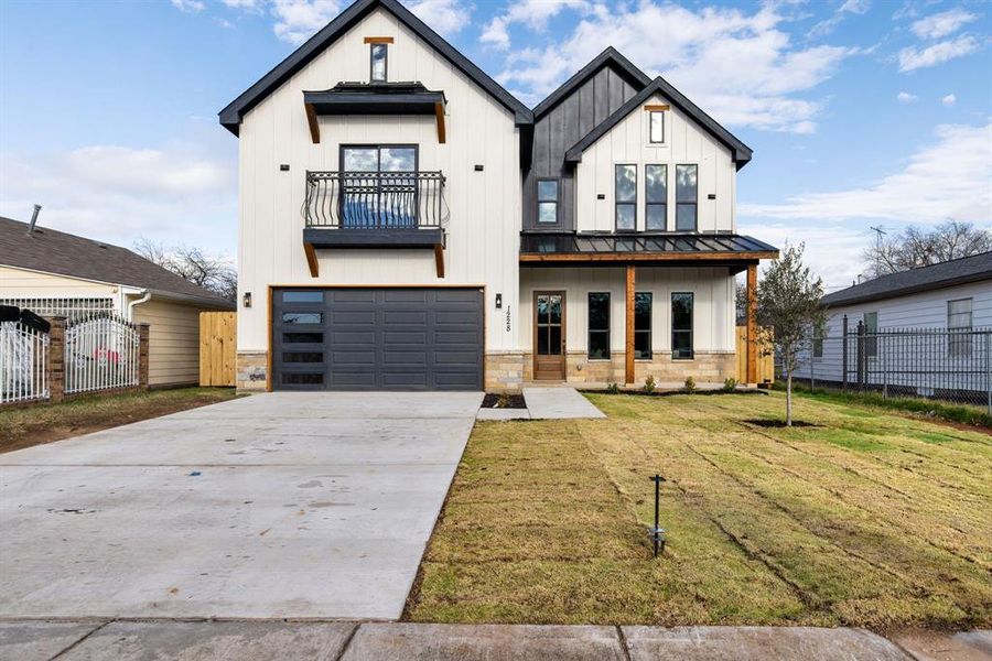 Modern farmhouse style home with a balcony, a front lawn, and a garage