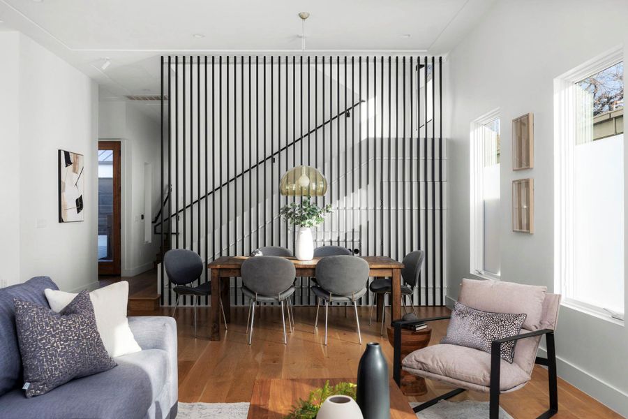 Living room with hardwood / wood-style flooring and hanging lights