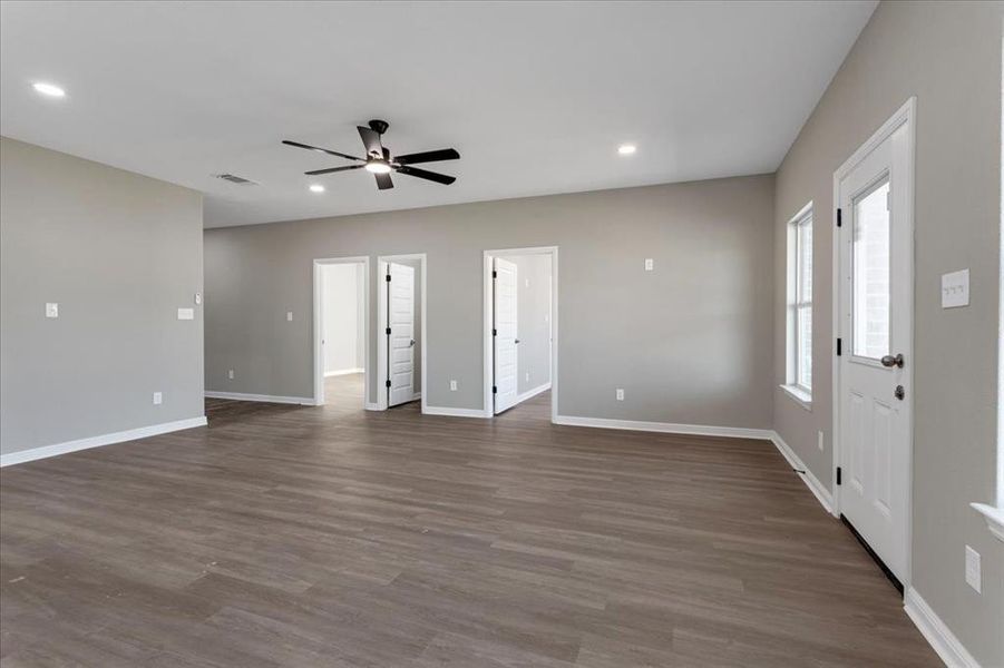 Unfurnished living room with recessed lighting, dark wood-type flooring, and a ceiling fan