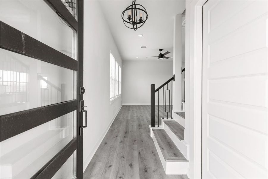 Bright and airy entryway greets you with high ceilings and sleek tile flooring throughout first floor.