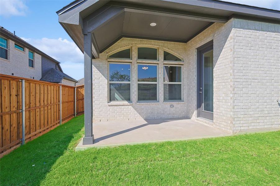 Back of house featuring a patio area and a lawn