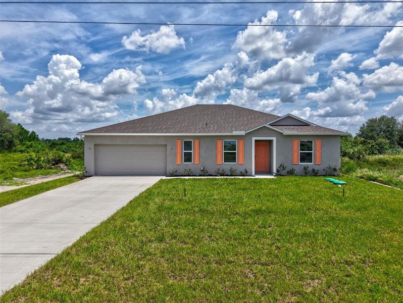 Front exterior of a new home in , Lehigh Acres, FL, highlighting curb appeal (Image 1). Front exterior of a new home in , Lehigh Acres, FL, highlighting curb appeal (Image 1).