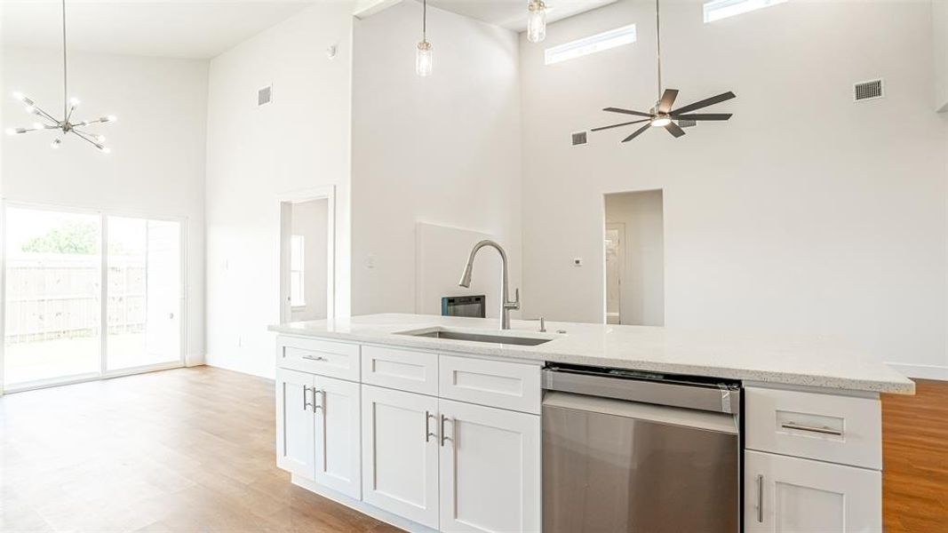 Living area with decorative fan and electric fireplace.