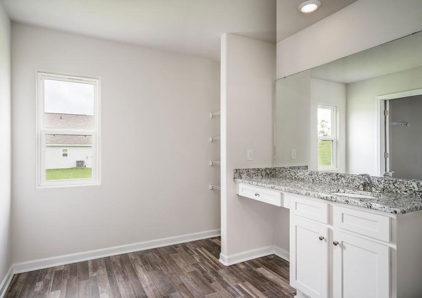 Master bathroom with a large vanity, white cabinets and vinyl flooring.