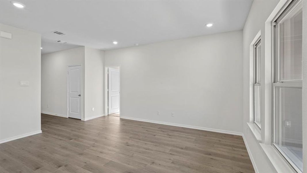 Spare room with recessed lighting and dark wood-style flooring