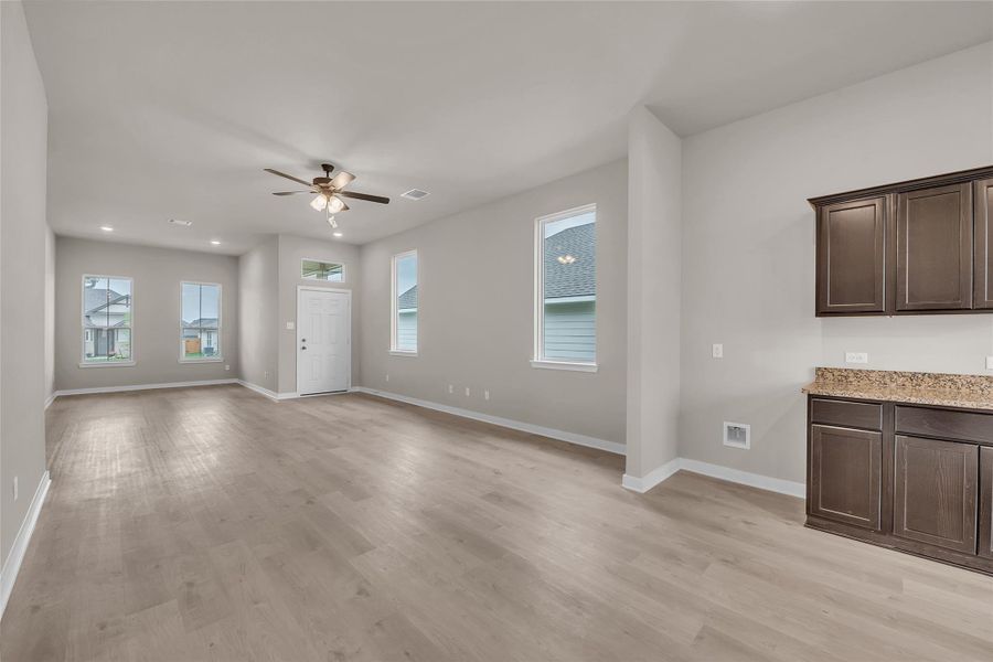 Unfurnished living room featuring ceiling fan, light wood-style floors, and recessed lighting