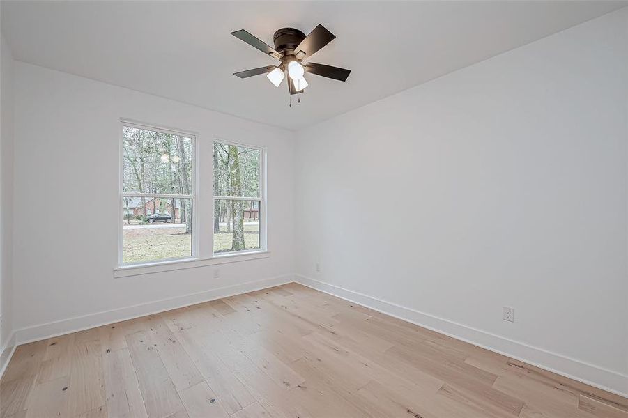 Study with large windows providing natural light.