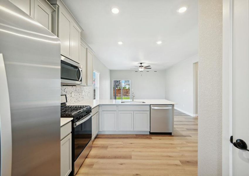 The kitchen sits in between the dining room and the family room.