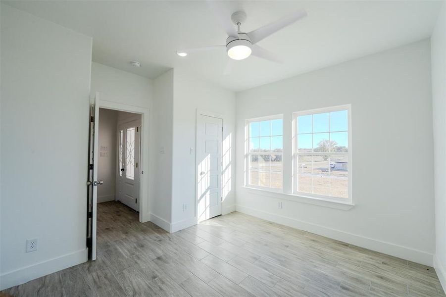Bedroom (1) with light wood finished floors, ceiling fan, and recessed lighting. Bedroom (1) with light wood finished floors, ceiling fan, and recessed lighting.