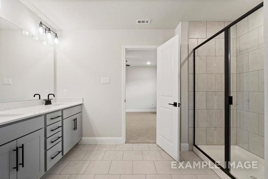 Bathroom with tile patterned floors, vanity, and walk in shower