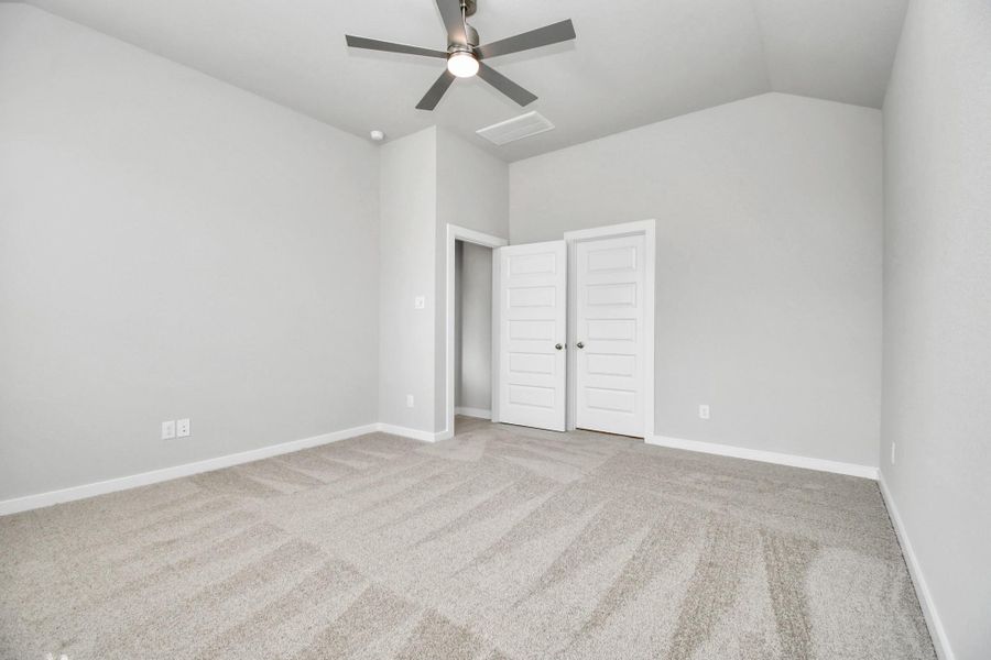 Relax and rejuvenate in the luxurious primary suite after a hectic day! This expansive space boasts cozy carpeting, inviting paint tones, lofty ceilings, and sizable windows adorned with privacy blinds. Sample photo of completed home with similar floor plan. Actual colors and selections may vary.