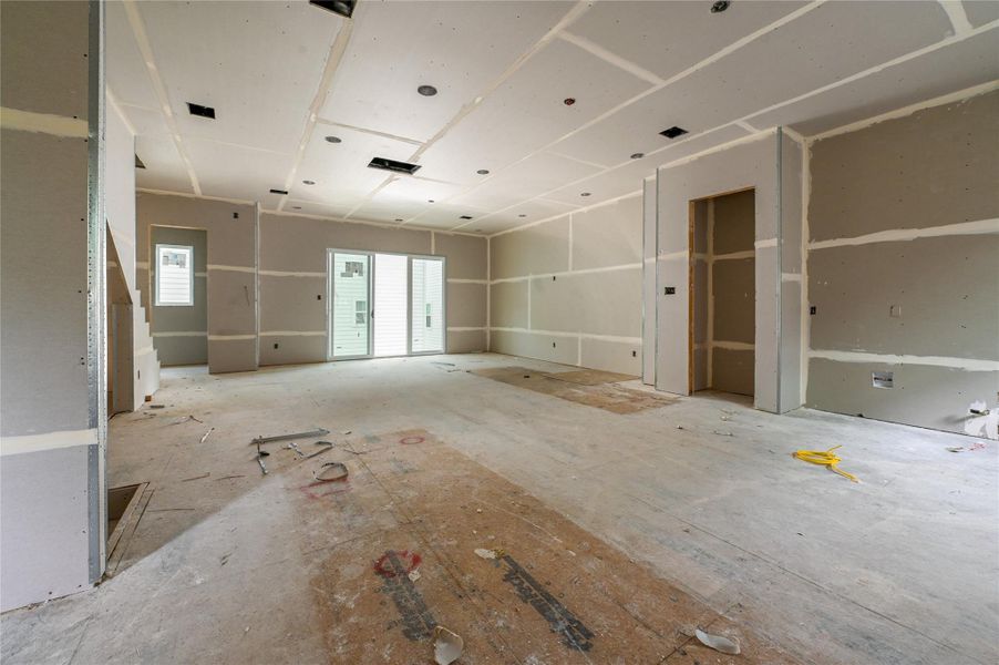 Living room and kitchen open floor plan with high ceilings