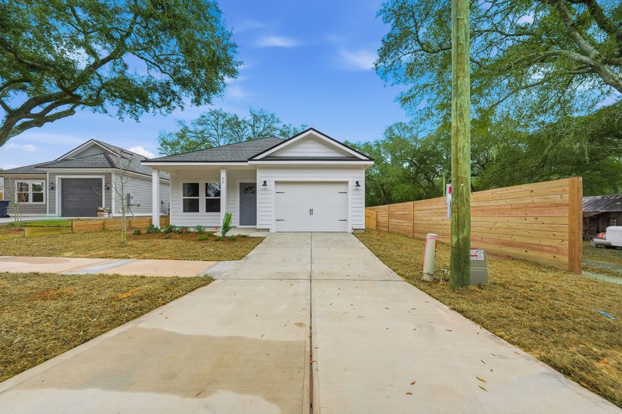 Front exterior of a new home in Live Oak Cottages, Freeport, FL, highlighting curb appeal (Image 2). Front exterior of a new home in Live Oak Cottages, Freeport, FL, highlighting curb appeal (Image 2).