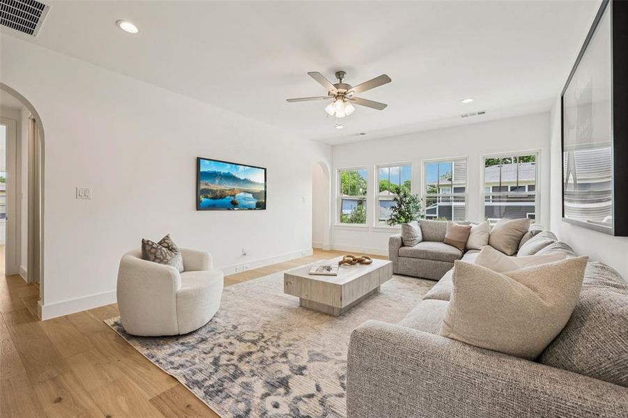 Living area featuring wood-finish flooring and recessed lighting