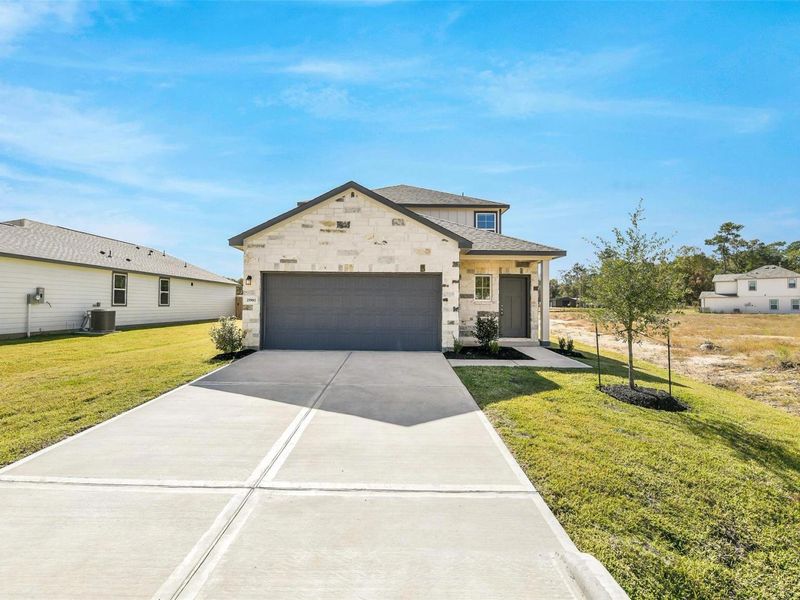 Front exterior of a new home in Liberty Estates, Cleveland, TX, highlighting curb appeal (Image 2). Front exterior of a new home in Liberty Estates, Cleveland, TX, highlighting curb appeal (Image 2).