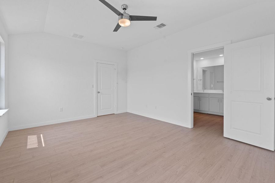 Unfurnished bedroom featuring light wood-type flooring and ceiling fan Unfurnished bedroom featuring light wood-type flooring and ceiling fan