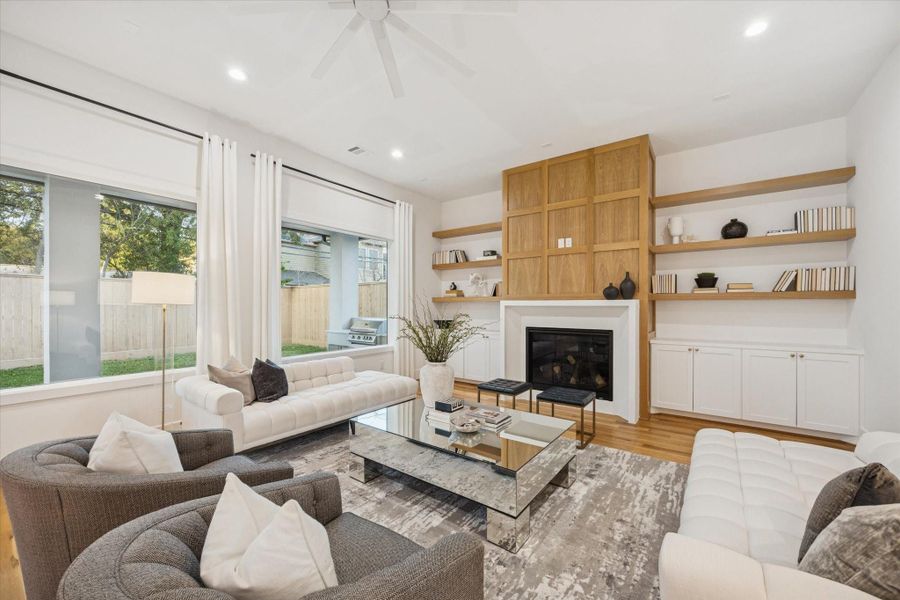 As the central gathering space, the living room balances comfort and function with generous seating areas and direct connection to the backyard. Custom white oak millwork frames the fireplace and built in storage, creating a warm focal point while keeping the space organized and open for everyday living or entertaining. As the central gathering space, the living room balances comfort and function with generous seating areas and direct connection to the backyard. Custom white oak millwork frames the fireplace and built in storage, creating a warm focal point while keeping the space organized and open for everyday living or entertaining.