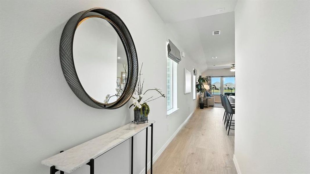 Hallway with baseboards and light wood-style flooring