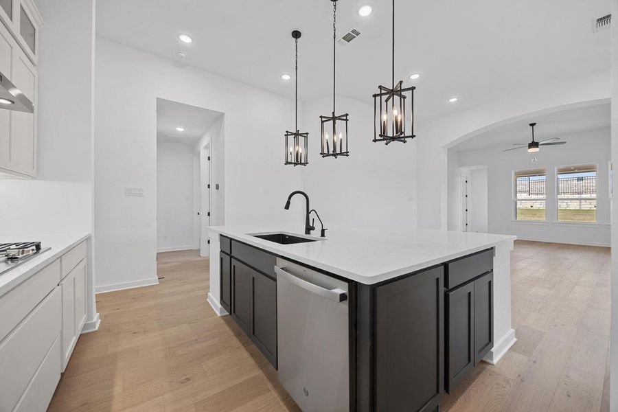 Kitchen with appliances with stainless steel finishes, a ceiling fan, light wood-style floors, white cabinetry, and recessed lighting