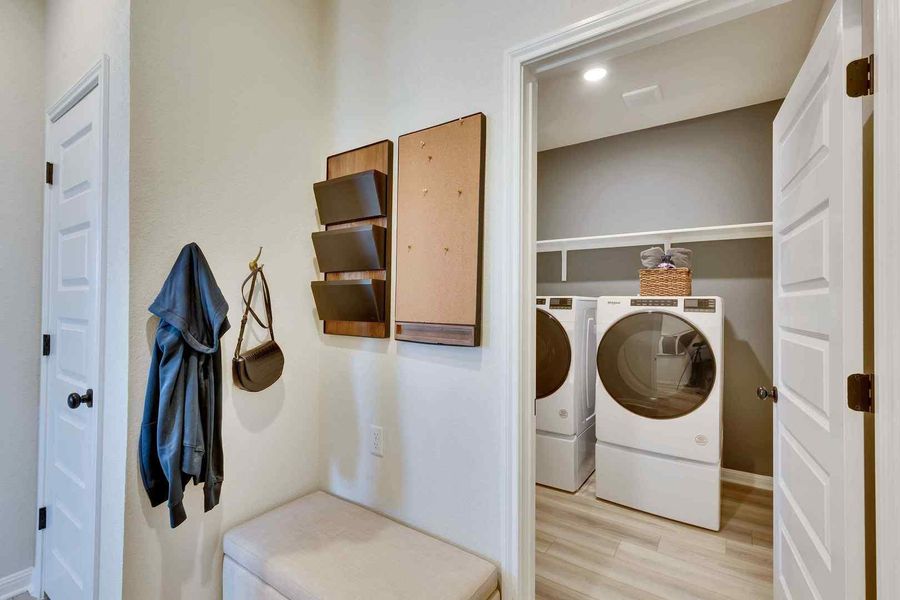 Functional laundry space featuring modern appliances and convenient storage solutions.