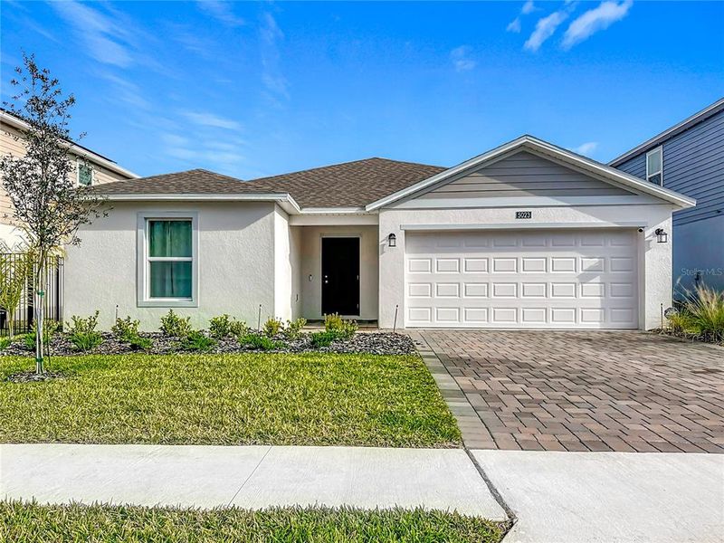 Front exterior of a new home in Providence, Davenport, FL, highlighting curb appeal (Image 25).