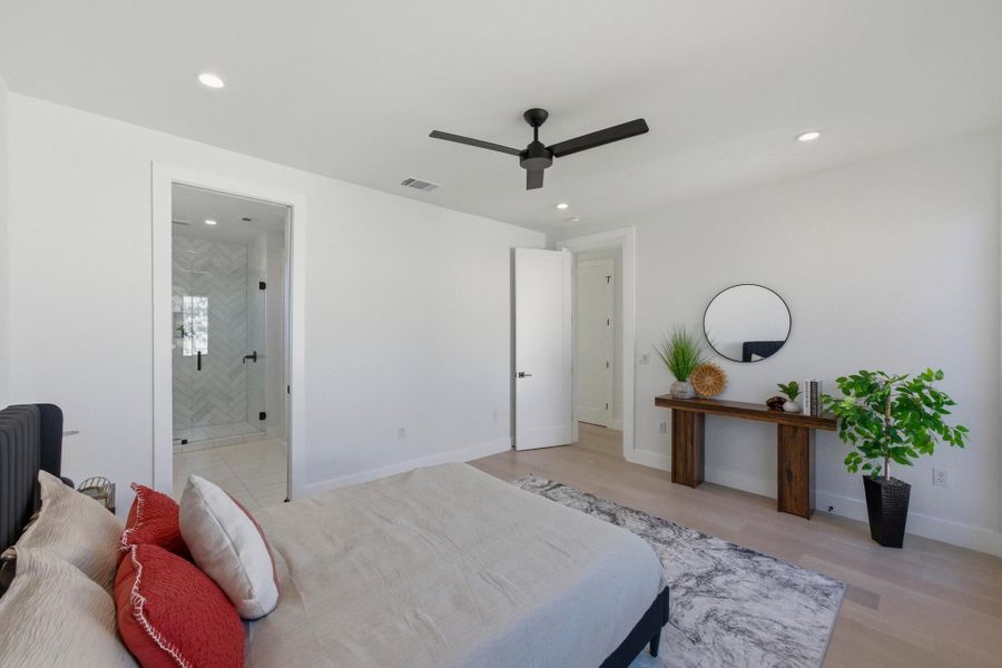 Bedroom featuring a ceiling fan, light wood-style flooring, and recessed lighting
