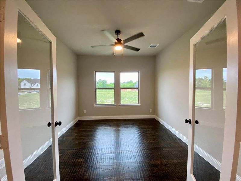 Great study with double doors, ceiling fan, and Ebony hardwood floors