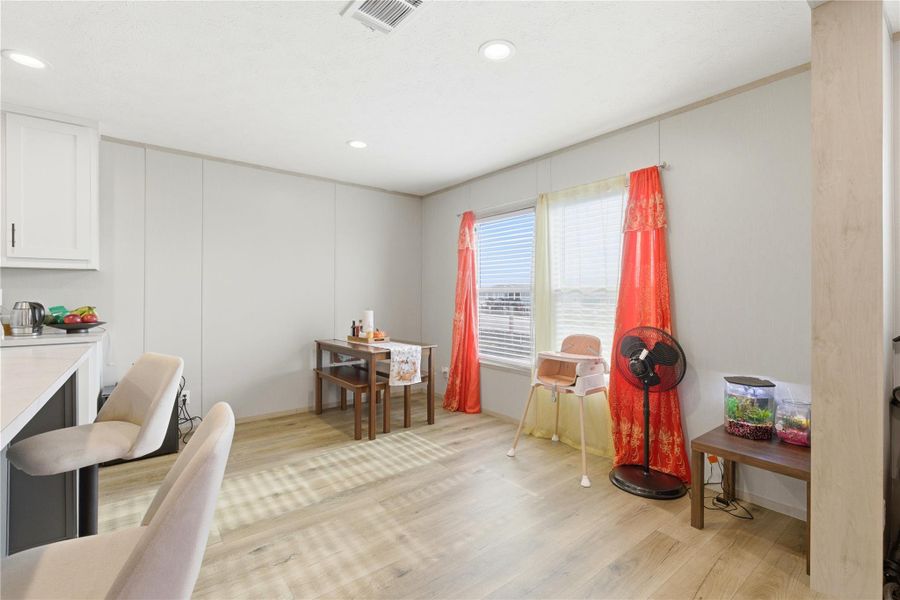 A well-lit dining area and kitchen bar offers casual gathering space for daily meals.