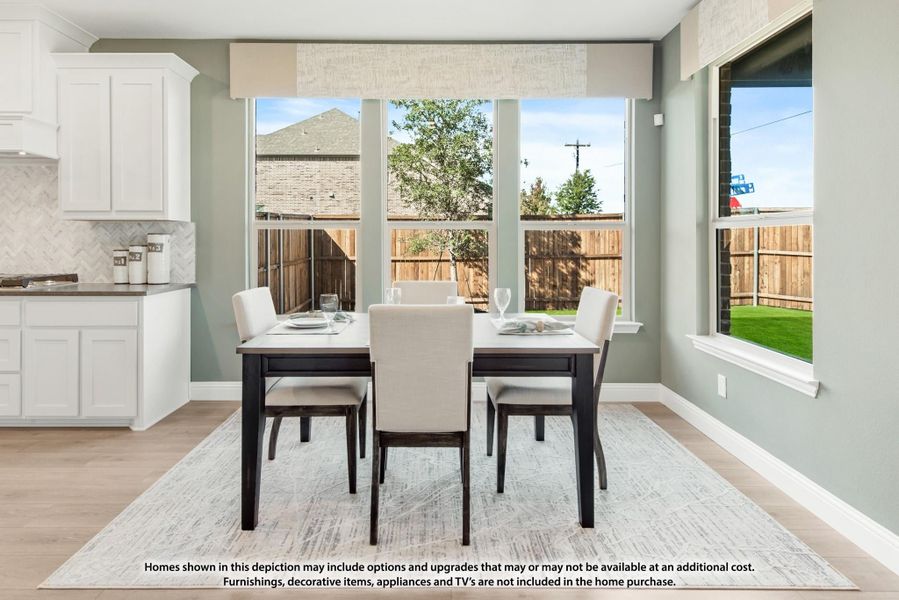 Dining area with dark wood table, four upholstered chairs, light wood floors, and large windows overlooking a fenced backyard. Dining area with dark wood table, four upholstered chairs, light wood floors, and large windows overlooking a fenced backyard.