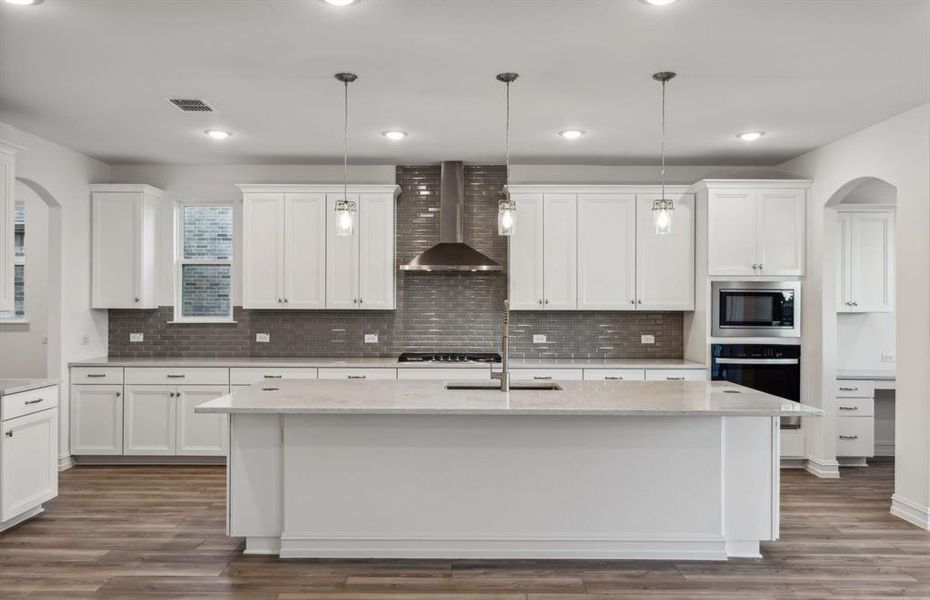 Airy kitchen with oversized island and ample cabinet space *real home pictured