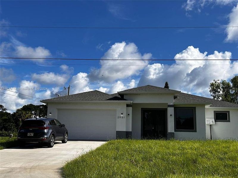 Front exterior of a new home in , Lehigh Acres, FL, highlighting curb appeal (Image 2). Front exterior of a new home in , Lehigh Acres, FL, highlighting curb appeal (Image 2).