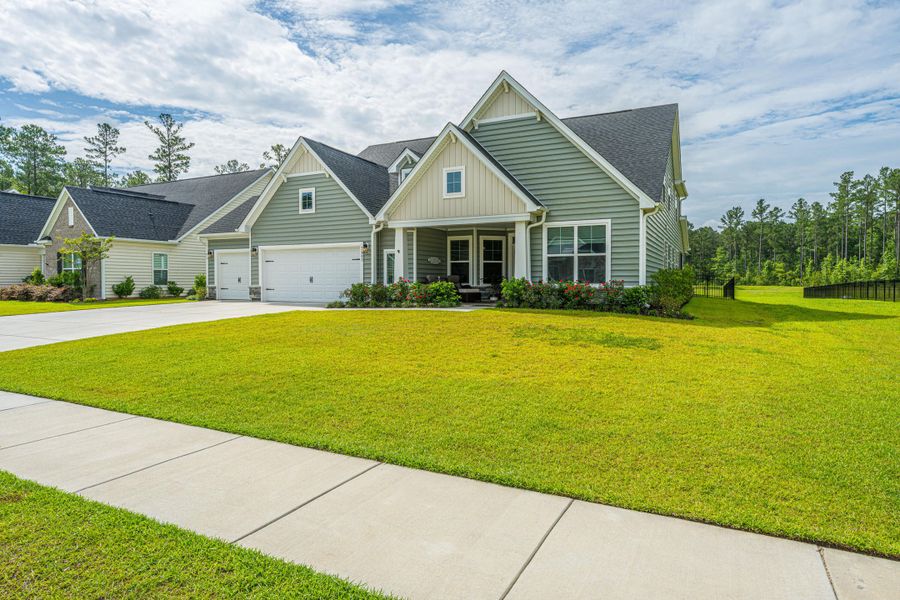 Front exterior of a new home in The Enclave at French Quarter Creek, Huger, SC, highlighting curb appeal (Image 28). Front exterior of a new home in The Enclave at French Quarter Creek, Huger, SC, highlighting curb appeal (Image 28).