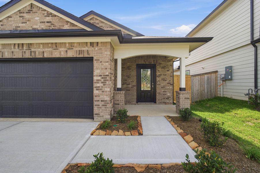 Front exterior of a new home in The Pines at Seven Coves, Willis, TX, highlighting curb appeal (Image 17).