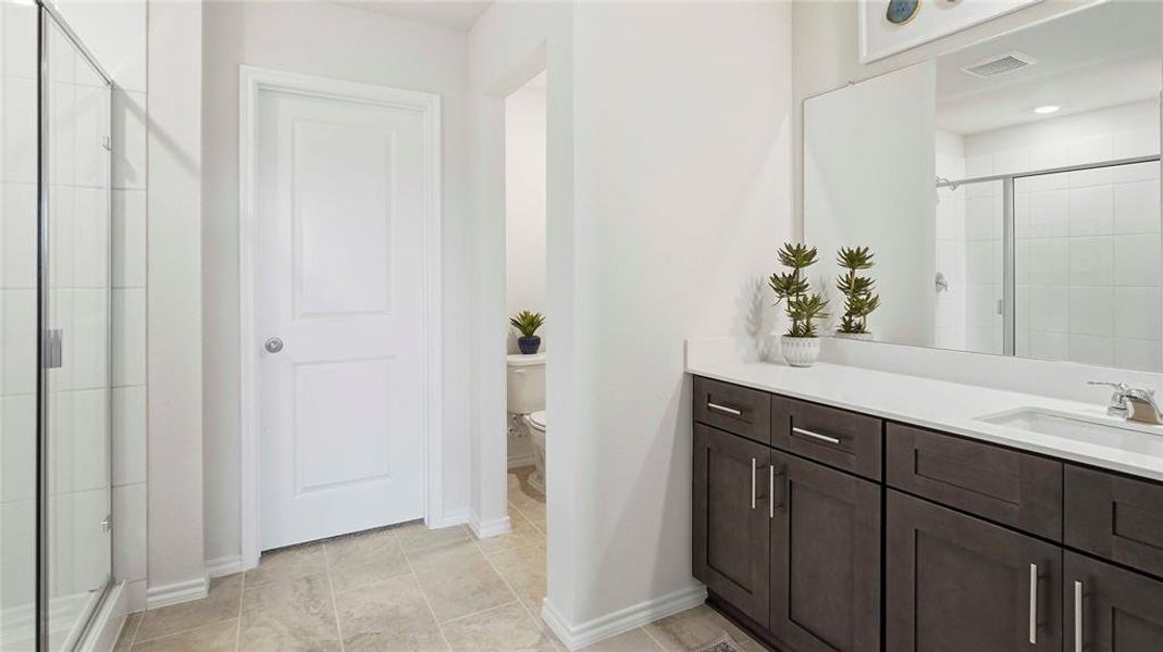 Full bathroom with a shower stall, vanity, and recessed lighting