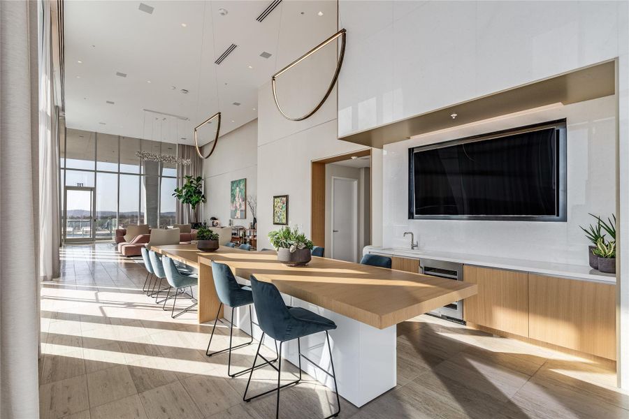 An inviting gathering space features lofty ceilings, a long breakfast bar, and a wet bar. An inviting gathering space features lofty ceilings, a long breakfast bar, and a wet bar.