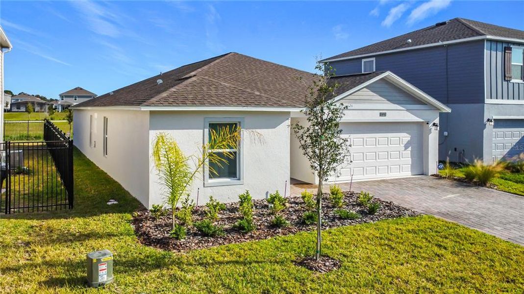 Front exterior of a new home in Providence, Davenport, FL, highlighting curb appeal (Image 27).