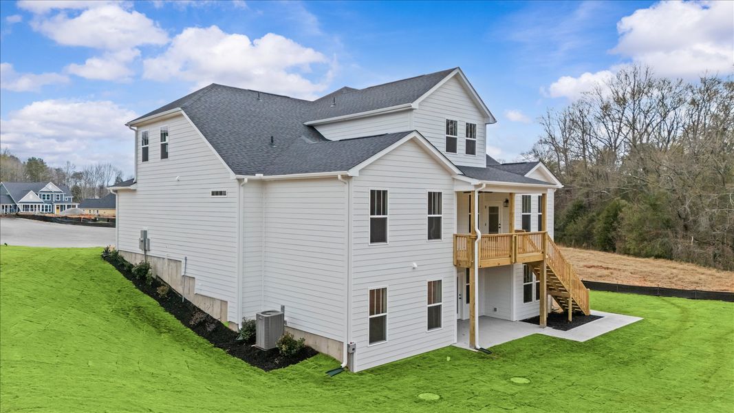 Rear covered porch offers a private, first-rate setting for outdoor enjoyment