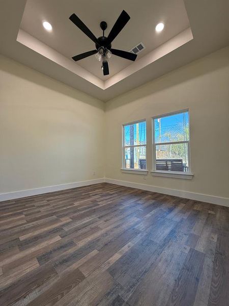 Office  bedroom looking outside front porch and tray box ceiling and high baseboards throughout the house and trim.