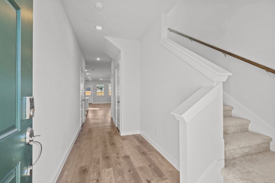A hallway with white walls.